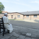 Pope Francis during a moment of reflection as he sits in front of camp buildings in Auschwitz.